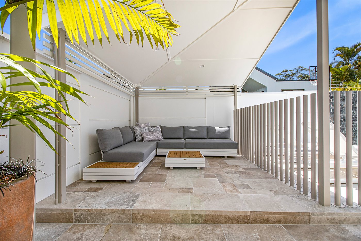 Covered outdoor lounge area with built-in seating on a Sunshine Coast property